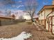 Large backyard with gravel, shed, and partial snow cover at 1390 E Southern St, Brighton, CO 80601