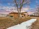 House with backyard, tree, and snow at 1390 E Southern St, Brighton, CO 80601