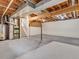 Unfinished basement with exposed beams and high ceilings at 1390 E Southern St, Brighton, CO 80601