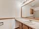 Bathroom with wood vanity and large mirror at 1390 E Southern St, Brighton, CO 80601