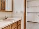 Clean bathroom with wood vanity and linen closet at 1390 E Southern St, Brighton, CO 80601