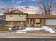 House exterior showcasing the front entrance and landscaping during winter season at 1390 E Southern St, Brighton, CO 80601