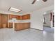 Kitchen with oak cabinets, island, and view into adjacent dining area at 1390 E Southern St, Brighton, CO 80601