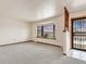 Bright living room featuring bay window, wood-style accents, and neutral carpeting at 1390 E Southern St, Brighton, CO 80601