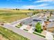 Neighborhood aerial view showcasing houses with solar panels and green spaces in a modern development at 581 Park Blvd, Brighton, CO 80603