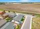 Aerial view of a single-Gathering house with a backyard surrounded by many houses and farmland at 581 Park Blvd, Brighton, CO 80603