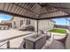 Well-maintained backyard features a concrete patio with seating, a grill, and small grass area at 581 Park Blvd, Brighton, CO 80603