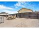 Private backyard with concrete patio, outdoor dining set, metal gazebo, gravel, and dark wood fence at 581 Park Blvd, Brighton, CO 80603