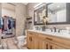 Modern bathroom boasts double sinks, wood cabinets, contemporary mirrors, and an attached closet at 581 Park Blvd, Brighton, CO 80603