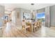 Dining room with a large window, contemporary light fixture, and a view into the entrance way at 581 Park Blvd, Brighton, CO 80603