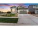 Charming home featuring a well-manicured lawn and a beautiful stone-accented facade, set against a vibrant sunset at 581 Park Blvd, Brighton, CO 80603
