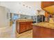 Kitchen and living space features wood cabinets, an island with an undermount sink and stainless steel appliances at 581 Park Blvd, Brighton, CO 80603