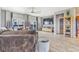Relaxing living room features gray sofa, large-screen TV, wood floors, and decorative shelving at 581 Park Blvd, Brighton, CO 80603