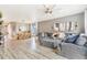 Bright and airy living room with a large sectional sofa and a view into the dining area at 581 Park Blvd, Brighton, CO 80603