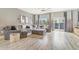 Spacious living room features a plush gray sectional sofa, ottoman, and sliding glass door to the outdoors at 581 Park Blvd, Brighton, CO 80603