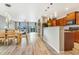 Open concept living space with dining area, living room, kitchen and light colored wood flooring throughout at 581 Park Blvd, Brighton, CO 80603