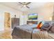 Comfortable main bedroom with a large bed, wood floors, and TV; ensuite bath visible in background at 581 Park Blvd, Brighton, CO 80603