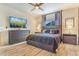 Bright main bedroom features modern furniture, wood floors, a ceiling fan, and a comfortable bed at 581 Park Blvd, Brighton, CO 80603