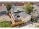 Aerial view of a home with a lovely backyard patio, a detached garage, and fencing at 8865 E 28Th Ave, Denver, CO 80238
