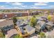Aerial view of a home with a nice backyard patio, a detached garage, and a fenced yard at 8865 E 28Th Ave, Denver, CO 80238