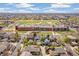 This aerial view highlights the neighborhood's layout and includes mature trees and a central school building at 8865 E 28Th Ave, Denver, CO 80238