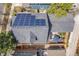 Aerial view of a house featuring solar panels, patio and fenced backyard at 8865 E 28Th Ave, Denver, CO 80238