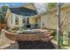 Beautiful backyard with a brick patio, table, chairs and flower garden at 8865 E 28Th Ave, Denver, CO 80238