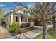 Charming yellow home with a covered front porch, front yard landscaping, and a welcoming entrance at 8865 E 28Th Ave, Denver, CO 80238