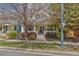 Quaint yellow house with front porch and manicured landscaping, showcasing curb appeal at 8865 E 28Th Ave, Denver, CO 80238