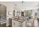 Kitchen with granite countertops open to the living room, featuring modern stainless appliances at 8865 E 28Th Ave, Denver, CO 80238