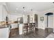 Kitchen with stainless appliances, breakfast bar, wood floors and white cabinetry at 8865 E 28Th Ave, Denver, CO 80238
