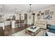 Open-concept kitchen and living area with a marble island and hardwood floors at 8865 E 28Th Ave, Denver, CO 80238
