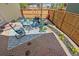 Brick patio featuring a glass table with chairs, flowers, and a privacy fence at 8865 E 28Th Ave, Denver, CO 80238