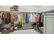 Organized walk-in closet with shelves, rods, and a cozy seating area at 8865 E 28Th Ave, Denver, CO 80238