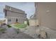 Spacious backyard featuring well-manicured lawn, stone landscaping, and cozy patio space at 1206 Sugarloaf Ln, Erie, CO 80516