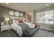 Comfortable bedroom showcasing neutral tones, a cozy bed, and decorative wall art at 1206 Sugarloaf Ln, Erie, CO 80516
