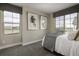 Bright bedroom featuring neutral walls, plush carpet, and natural light from two large windows at 1206 Sugarloaf Ln, Erie, CO 80516