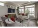 Bright and airy living room featuring large windows, comfortable seating, and modern decor at 1206 Sugarloaf Ln, Erie, CO 80516