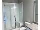 The bathroom has a sleek glass-enclosed shower with a built-in bench, alongside a toilet and granite vanity at 14673 E Belleview Dr, Aurora, CO 80015