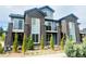 Stylish townhome featuring brick accents, a balcony, and well-maintained landscaping, offering a modern living experience at 14673 E Belleview Dr, Aurora, CO 80015