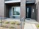 Modern townhome featuring stylish brick and a welcoming entrance, complemented by fresh landscaping at 14673 E Belleview Dr, Aurora, CO 80015