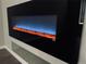 Modern living room featuring a sleek, built-in electric fireplace with a black surround, creating a cozy ambiance at 14673 E Belleview Dr, Aurora, CO 80015