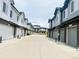 Modern townhome community with paved street, garages, and stylish exteriors in a well-maintained neighborhood at 14673 E Belleview Dr, Aurora, CO 80015