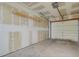 Spacious garage featuring unfinished walls, concrete floor, and overhead door at 12625 E Pacific Cir # E, Aurora, CO 80014