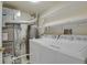 Efficient laundry room featuring a washer, dryer, water heater, and ample storage space at 12625 E Pacific Cir # E, Aurora, CO 80014