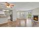 Open-concept living area with fireplace, new flooring, and bright, white kitchen at 12625 E Pacific Cir # E, Aurora, CO 80014
