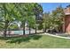 View of the community tennis courts, surrounded by lush greenery and mature trees at 12625 E Pacific Cir # E, Aurora, CO 80014