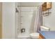 Bright bathroom features a shower, toilet and vanity with a wooden wall cabinet at 10381 Cook Way # 212, Thornton, CO 80229