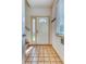 Entryway with neutral tiled floor, coat hooks and a window allowing natural light at 10381 Cook Way # 212, Thornton, CO 80229