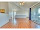 Bright living room with vaulted ceiling, hardwood floors, and sliding glass door to a balcony at 10381 Cook Way # 212, Thornton, CO 80229